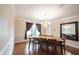 Cozy dining room featuring natural light, hardwood floors and modern lighting at 4976 Rockne Cir, Carmel, IN 46033