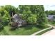 A charming two-story home with mature trees and manicured lawn on a quiet street at 4976 Rockne Cir, Carmel, IN 46033