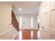 Bright foyer with hardwood floors, wainscoting and staircase at 4976 Rockne Cir, Carmel, IN 46033