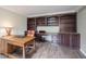Spacious home office with custom built-in shelving, desk, and hardwood floors at 4976 Rockne Cir, Carmel, IN 46033