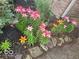 Landscaping featuring flowers in a flower bed next to a brick wall at 4976 Rockne Cir, Carmel, IN 46033