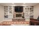 Bright living room with custom-built shelving and fireplace at 4976 Rockne Cir, Carmel, IN 46033