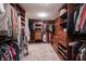 Spacious walk-in closet with custom shelving, drawers, and ample storage space at 4976 Rockne Cir, Carmel, IN 46033