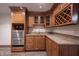 Basement wet bar offers stainless fridge and ample cabinet space for entertainment at 4976 Rockne Cir, Carmel, IN 46033