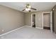 Comfortable bedroom with carpet, neutral paint, ceiling fan, and access to an ensuite bathroom at 5642 Southern Mist Dr, Indianapolis, IN 46237