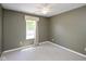 Neutral bedroom features a ceiling fan, carpeted floors, and a window for natural light at 5642 Southern Mist Dr, Indianapolis, IN 46237