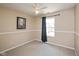 Carpeted bedroom with a ceiling fan, window with curtains, and neutral paint at 5642 Southern Mist Dr, Indianapolis, IN 46237