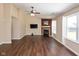 Bright living room featuring wood floors, a fireplace, ceiling fan, and lots of natural light at 5642 Southern Mist Dr, Indianapolis, IN 46237