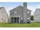 Back exterior showing a spacious yard and screened porch at 5672 High Timber Ln, Indianapolis, IN 46235