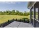 Backyard view from screened porch showing mature landscape at 5672 High Timber Ln, Indianapolis, IN 46235