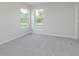 An inviting bedroom features neutral carpet and double windows overlooking the trees in backyard at 5672 High Timber Ln, Indianapolis, IN 46235