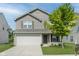 Charming two-story home with a two-car garage and a well-maintained front lawn at 5672 High Timber Ln, Indianapolis, IN 46235