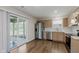 Modern kitchen with stainless steel appliances, light wood cabinets, and hardwood floors at 5672 High Timber Ln, Indianapolis, IN 46235