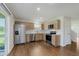 Modern kitchen with stainless steel appliances, light wood cabinets, and hardwood floors at 5672 High Timber Ln, Indianapolis, IN 46235