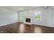 Bright living room featuring a fireplace, hardwood floors, and natural light at 5672 High Timber Ln, Indianapolis, IN 46235