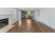 Open-concept floor plan featuring a fireplace, hardwood floors, and access to the kitchen at 5672 High Timber Ln, Indianapolis, IN 46235