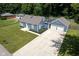A beautiful blue home with a long driveway, two-car garage, and manicured landscaping at 5902 Oak Ln, Anderson, IN 46013
