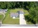 Aerial view showcasing the blue home's layout, backyard, and long driveway to the two-car garage at 5902 Oak Ln, Anderson, IN 46013