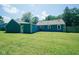 Spacious backyard with a well-maintained lawn and a blue house with white trim accents at 5902 Oak Ln, Anderson, IN 46013