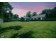 A lush backyard, perfect for outdoor activities under colorful evening sky at 5902 Oak Ln, Anderson, IN 46013
