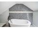 Beautiful bathroom featuring a freestanding tub with black faucet and mosaic tile accents at 5902 Oak Ln, Anderson, IN 46013