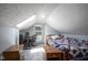 Cozy bedroom featuring sloped ceilings, a charming window, and a comfortable sleeping area with a patterned bedspread at 5902 Oak Ln, Anderson, IN 46013