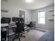 Small bedroom with grey walls, gaming setup and natural lighting at 5902 Oak Ln, Anderson, IN 46013