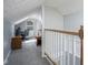 Bright bedroom with gray carpeting and light blue walls, featuring sloped ceilings and charming architectural details at 5902 Oak Ln, Anderson, IN 46013