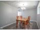 Cozy dining room with wooden table, chairs, and overhead lighting fixture at 5902 Oak Ln, Anderson, IN 46013