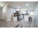 Open kitchen with white cabinets, island, stainless steel refrigerator, and modern lighting at 5902 Oak Ln, Anderson, IN 46013