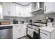 Bright kitchen with white cabinets, stainless steel appliances, and modern backsplash at 5902 Oak Ln, Anderson, IN 46013
