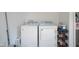 Functional laundry area equipped with a washer, dryer, and storage space for detergents and laundry essentials at 5902 Oak Ln, Anderson, IN 46013