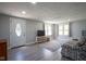 Bright living room with a decorative front door, new floors, large windows, and comfortable seating at 5902 Oak Ln, Anderson, IN 46013