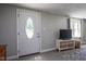 Inviting living room featuring a decorative front door, new floors and ample natural light at 5902 Oak Ln, Anderson, IN 46013