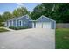 Spacious concrete driveway leads to a detached two-car garage, connecting to the home's rear entrance at 5902 Oak Ln, Anderson, IN 46013
