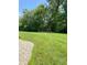 Beautifully landscaped backyard with well-manicured lawn, gravel area, and playground at 5993 E County Road 100 S, Avon, IN 46123