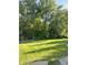 Expansive backyard featuring lush green lawn, mature trees, and a playset at 5993 E County Road 100 S, Avon, IN 46123