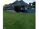 Exterior backyard view of the house with a spacious deck and well-maintained lawn at 5993 E County Road 100 S, Avon, IN 46123
