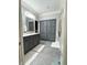 Bathroom featuring dark gray cabinets, granite countertops, and a large linen storage cabinet at 5993 E County Road 100 S, Avon, IN 46123