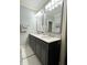 Gray bathroom featuring and sinks, modern vanity and a large framed mirror at 5993 E County Road 100 S, Avon, IN 46123