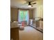 Bedroom featuring two cribs, a rocker, and a window providing natural light at 5993 E County Road 100 S, Avon, IN 46123