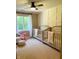 Charming Bedroom featuring two cribs, a window, and a fun pink flamingo rocker at 5993 E County Road 100 S, Avon, IN 46123