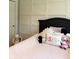 A bedroom with soft pink bedding, dark wood accents, and a whimsical collection of plush toys at 5993 E County Road 100 S, Avon, IN 46123