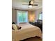 Comfortable bedroom with soft bedding, neutral walls, and a window dressed with elegant white curtains at 5993 E County Road 100 S, Avon, IN 46123