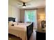 Cozy bedroom featuring a dark wood bed frame, soft pink bedding, and a window with natural light at 5993 E County Road 100 S, Avon, IN 46123