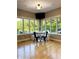 Breakfast nook with bright windows and a view of the backyard; chairs and a table, light fixture, and hardwood floors at 5993 E County Road 100 S, Avon, IN 46123