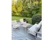 Outdoor deck space with neutral furniture and surrounded by lush greenery and trees at 5993 E County Road 100 S, Avon, IN 46123