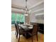 Open dining area with natural light, a modern chandelier, and views of backyard greenery at 5993 E County Road 100 S, Avon, IN 46123