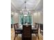 Dining room boasts an elegant chandelier and large windows with scenic backyard views at 5993 E County Road 100 S, Avon, IN 46123
