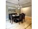 Elegant dining room features a refined chandelier, hardwood floors, and a modern buffet at 5993 E County Road 100 S, Avon, IN 46123